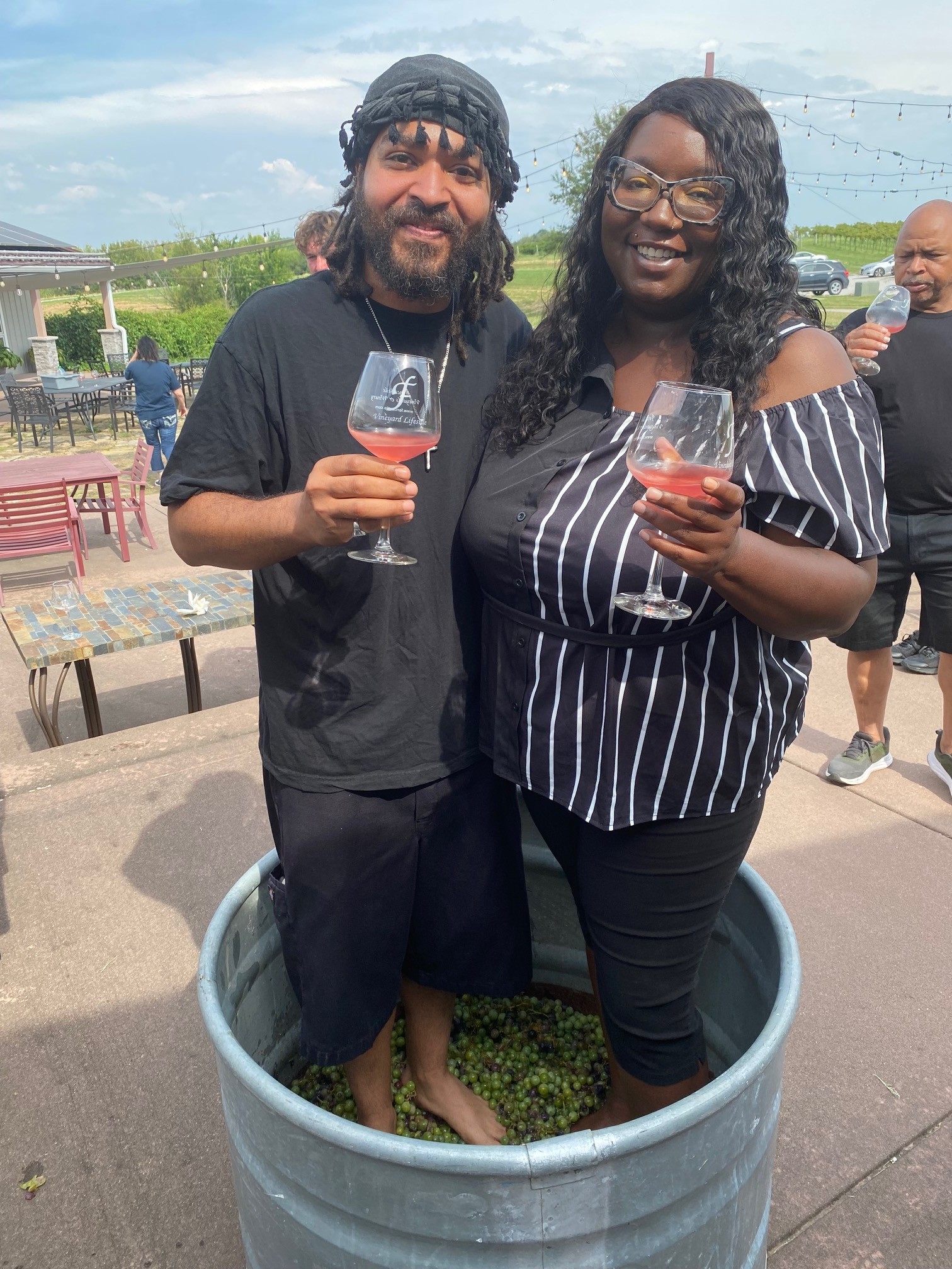 Guests celebrating together in the grape stomp tub at Fence Stile