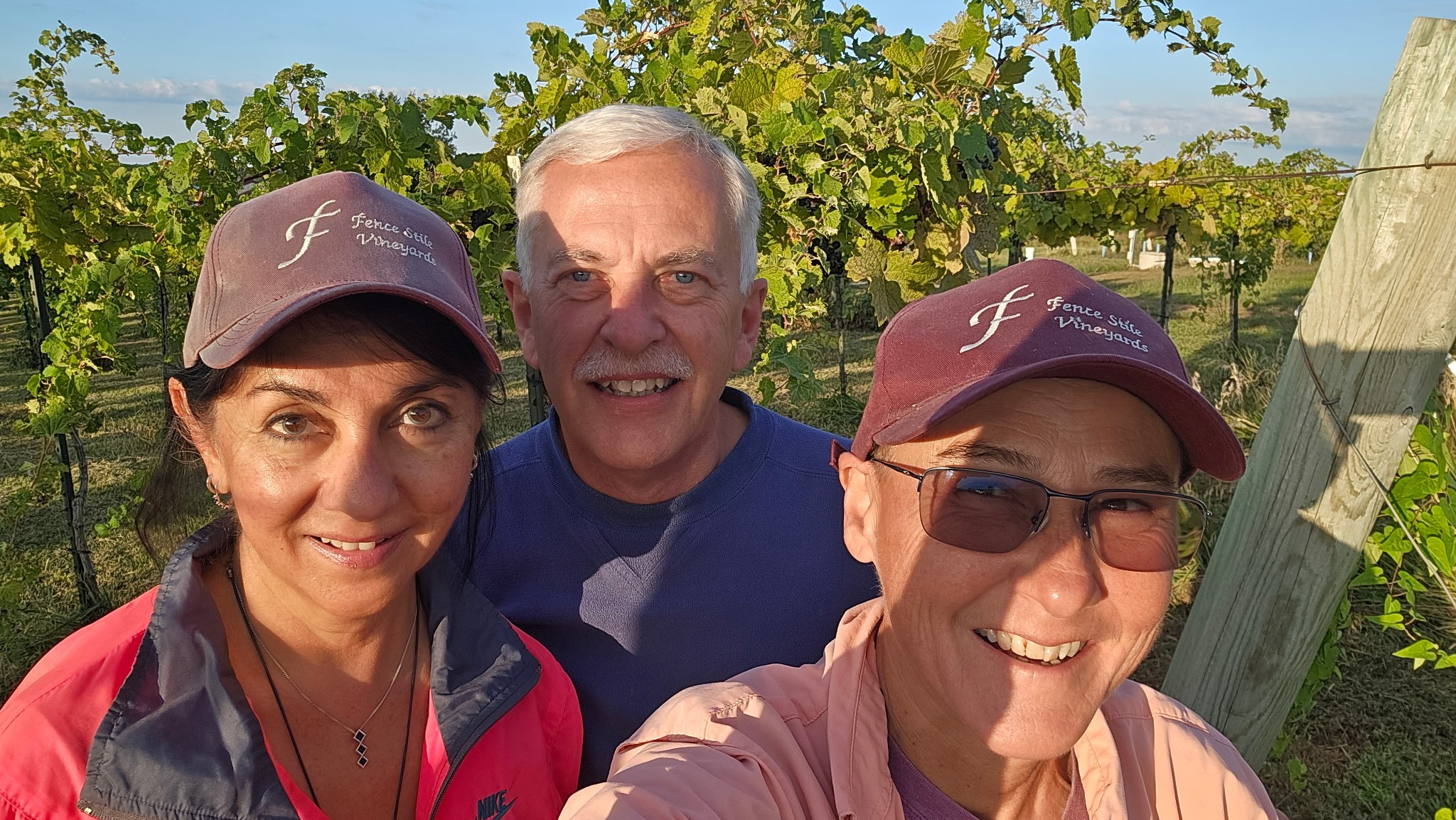 Three Fence Stile harvest team members smiling together in the vineyard