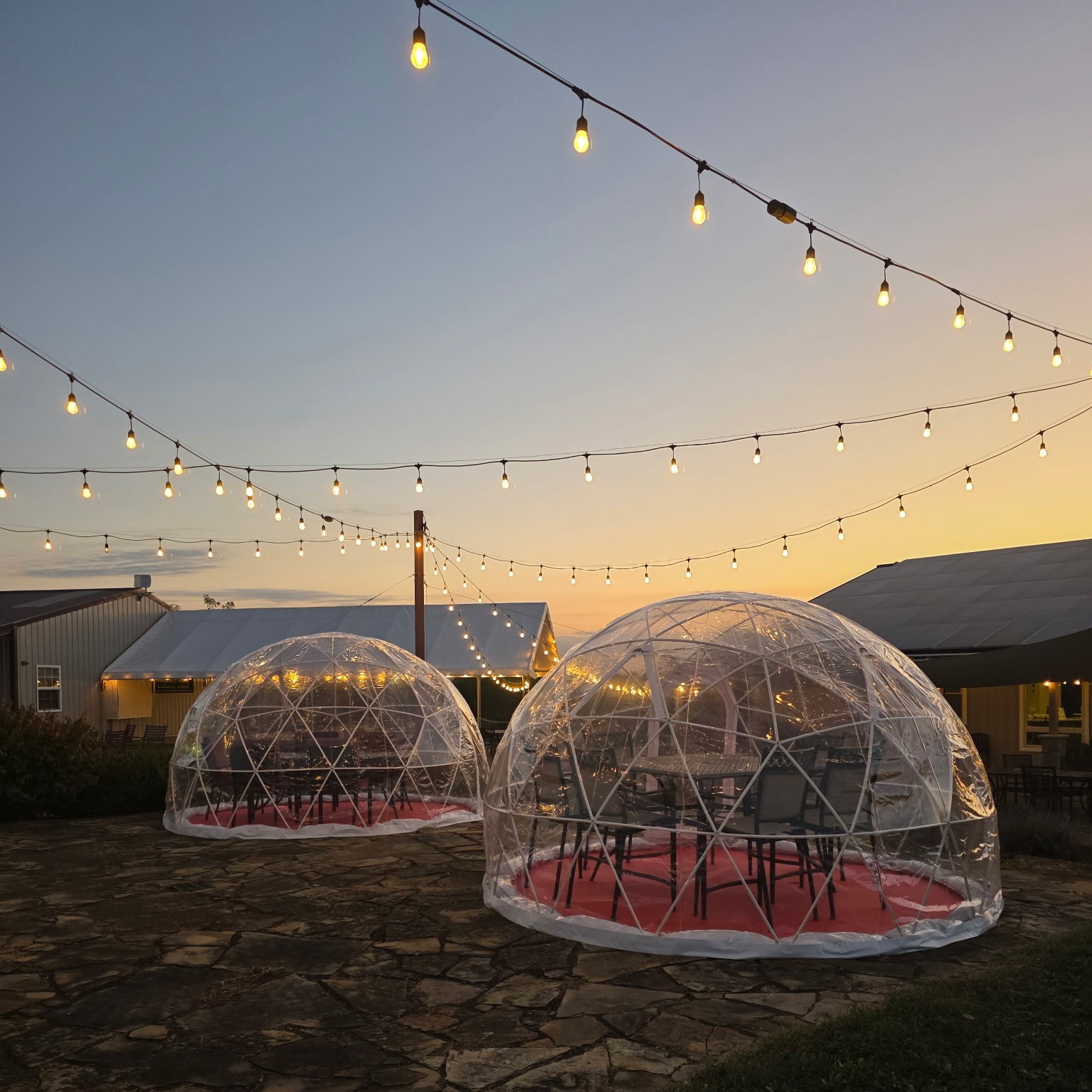 Lighted igloos on the Fence Stile patio at sunset