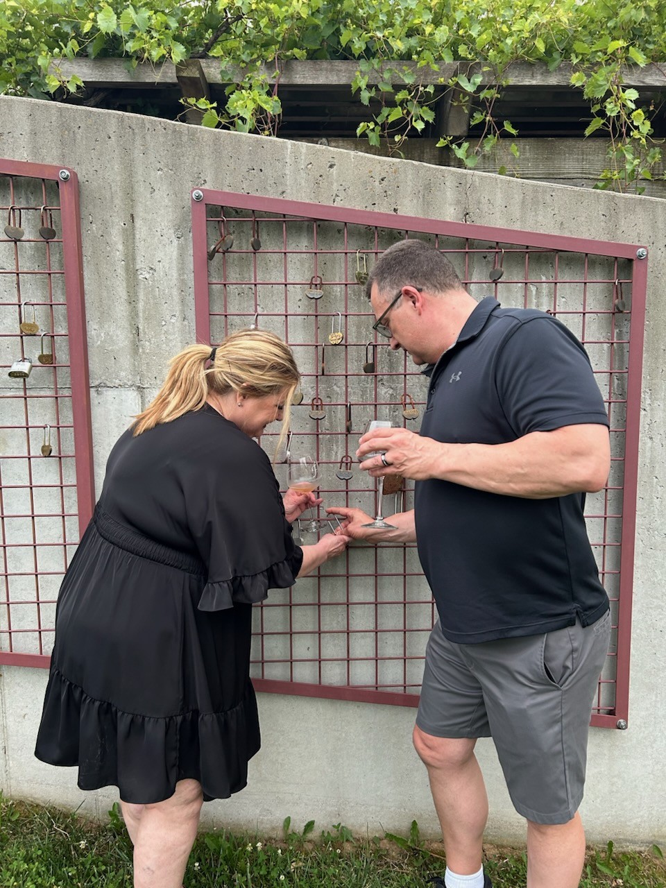 Couple adding a love lock at Fence Stile