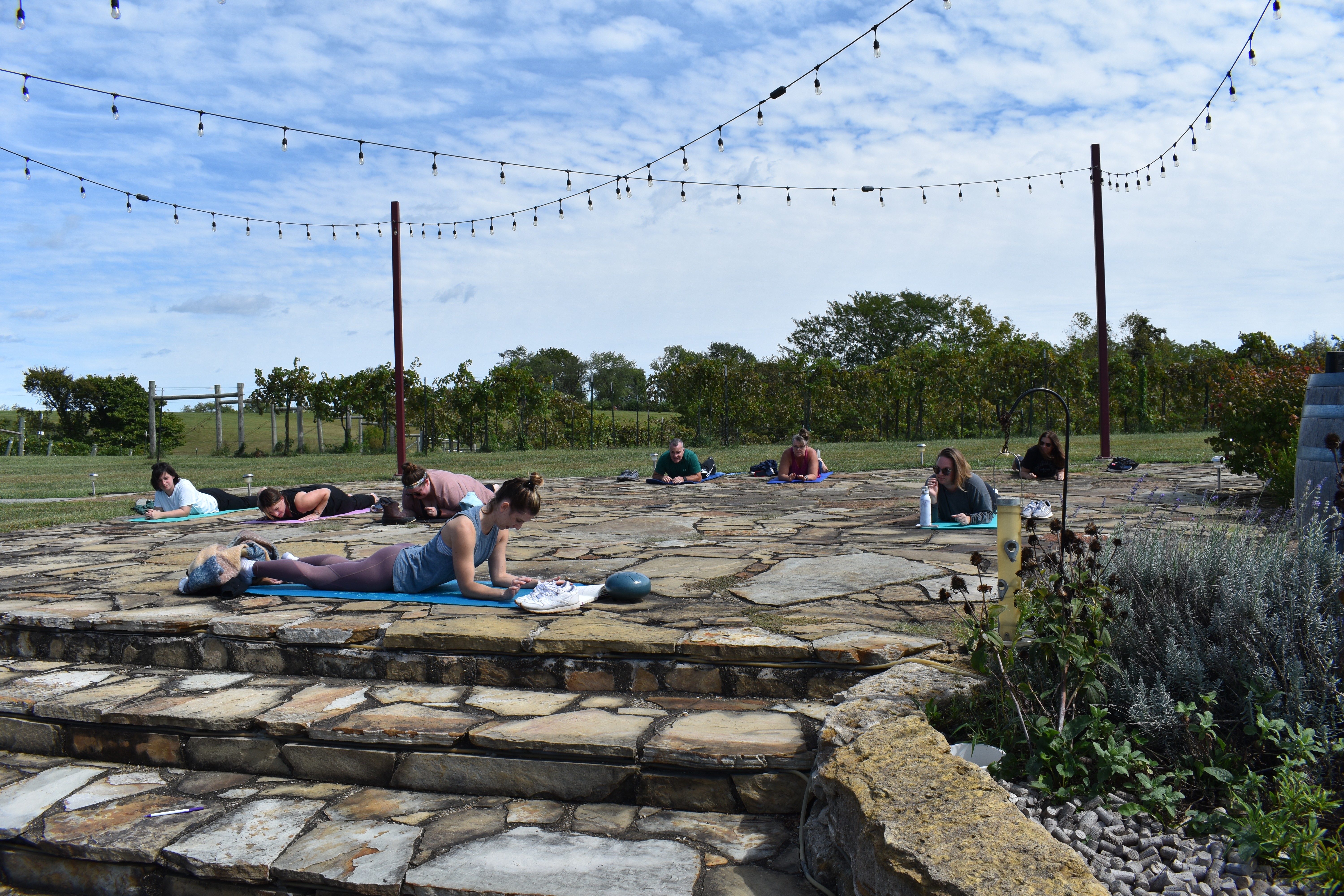 Outdoor wellness-adjacent retreat session on the patio at Fence Stile