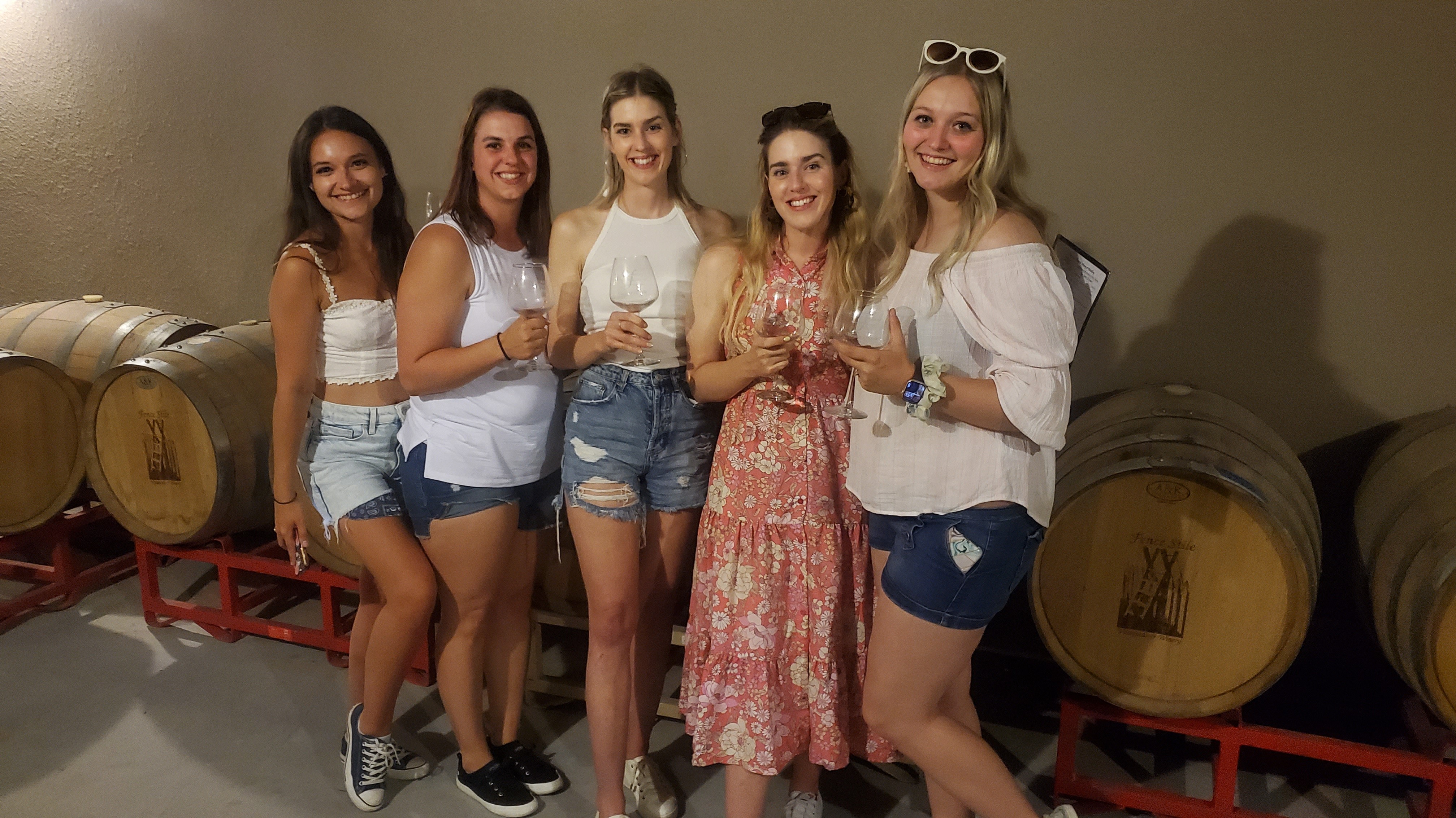 Friends gathered with wine in the Fence Stile wine cave