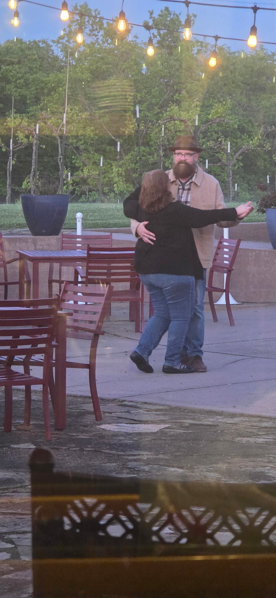 Couple dancing on the Fence Stile patio during an evening winery visit