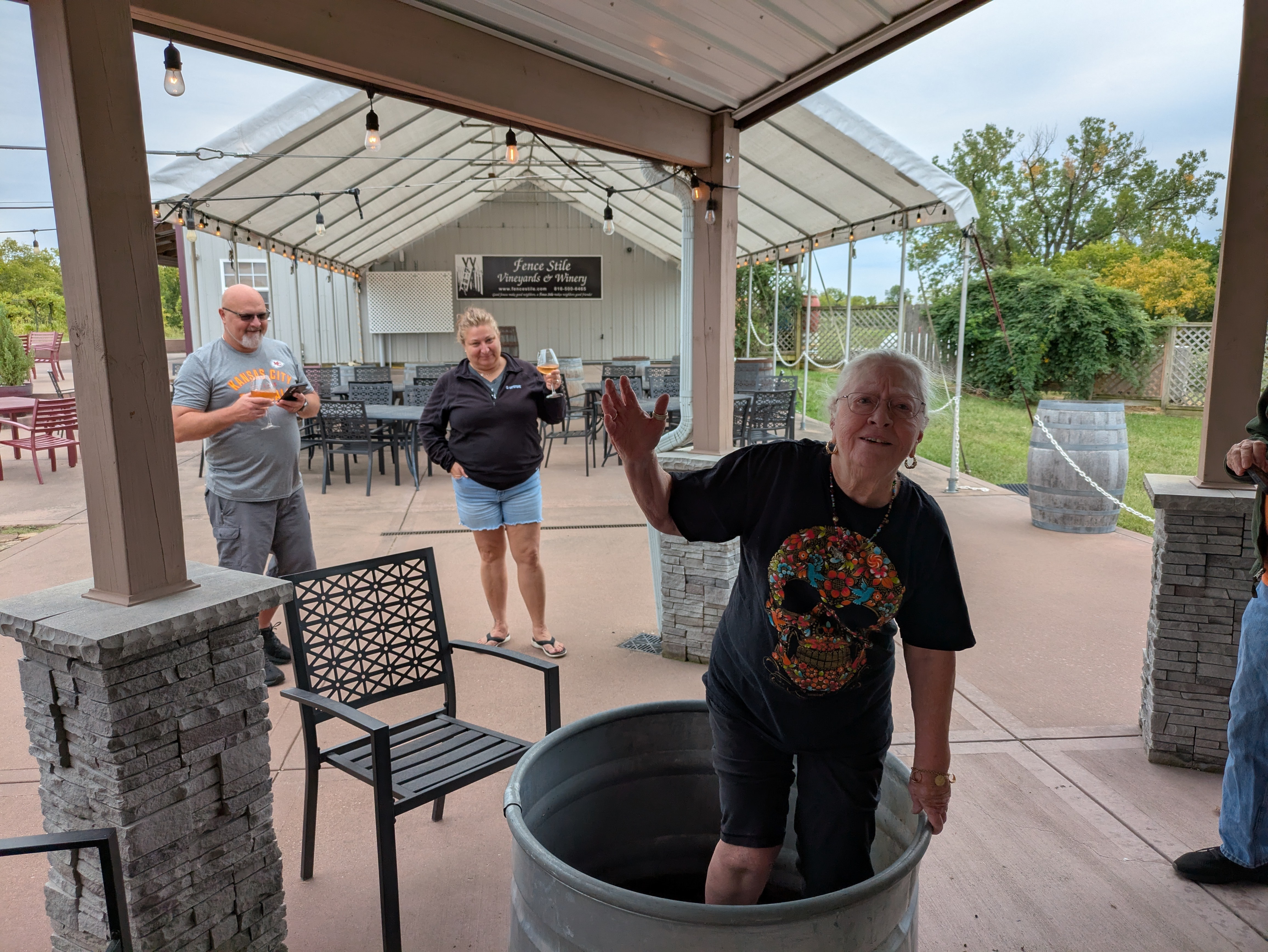 Guest participating in a seasonal grape stomp experience at Fence Stile
