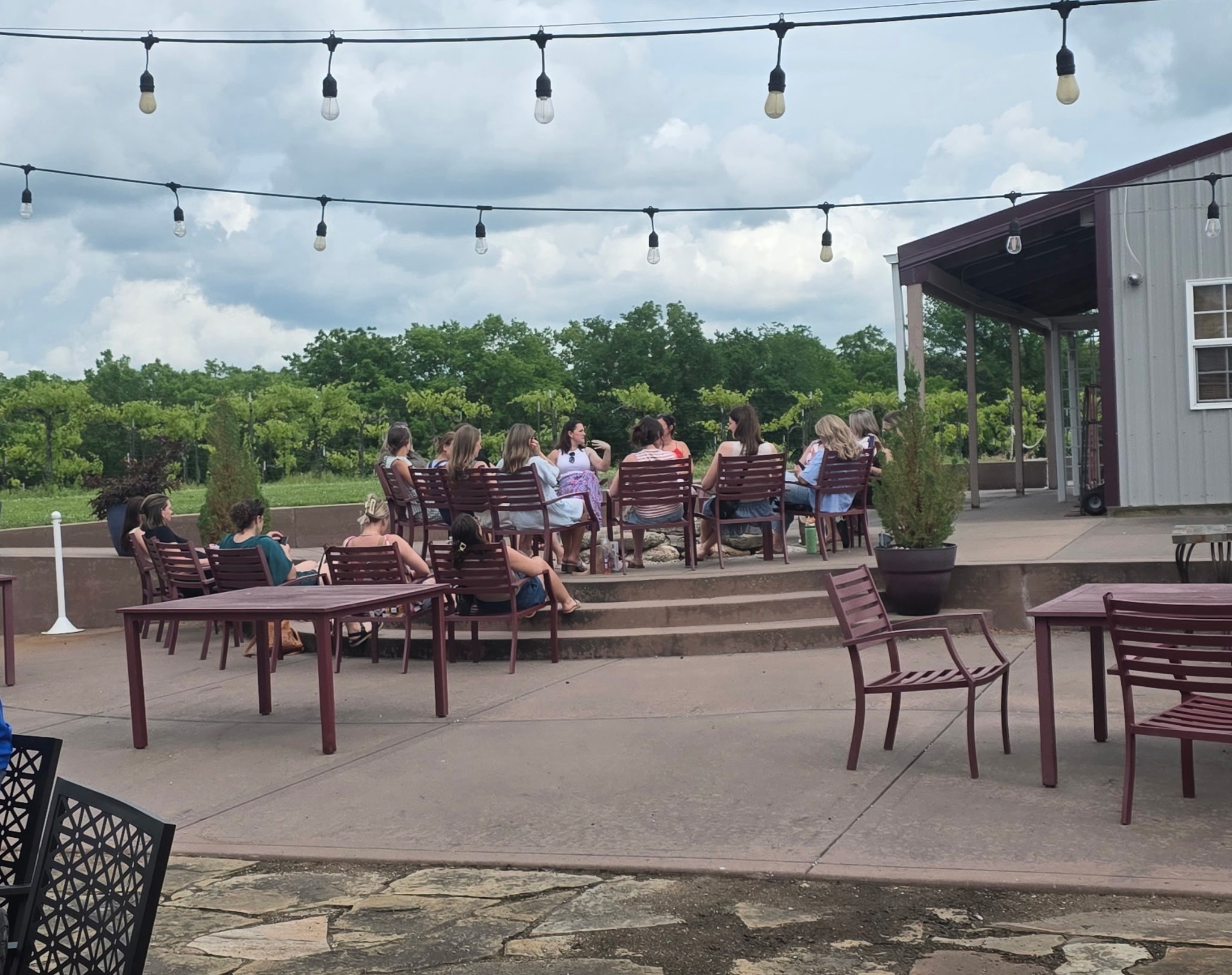 Friends relaxing together on the Fence Stile patio overlooking the vineyard