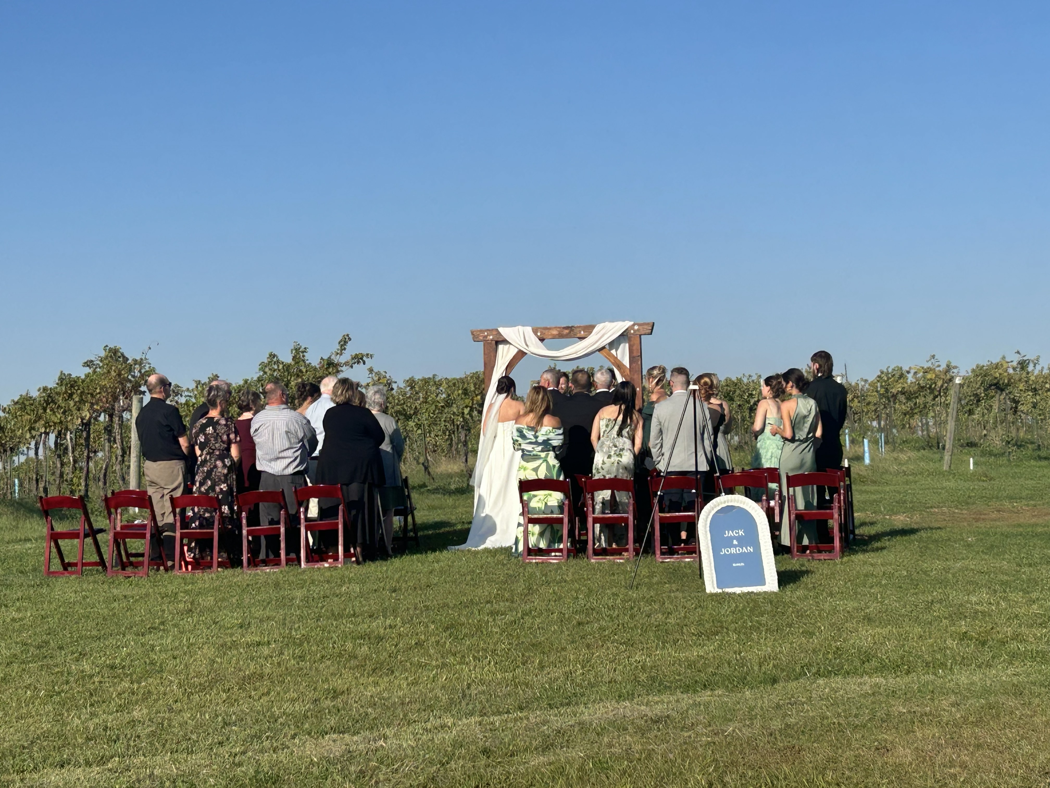 Wedding party gathered near the vineyard at Fence Stile